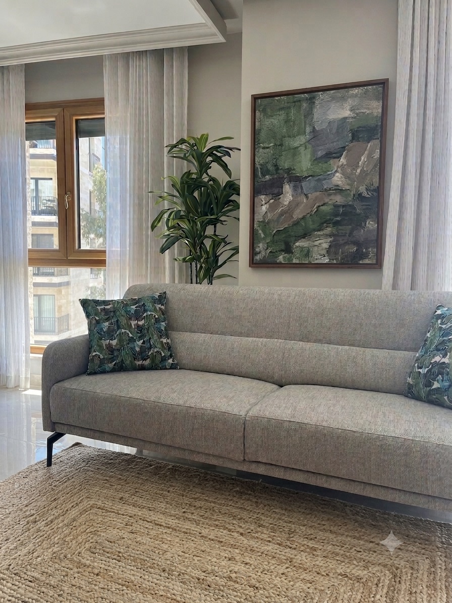 Living room with a grey linen sofa and botanical accent pillows