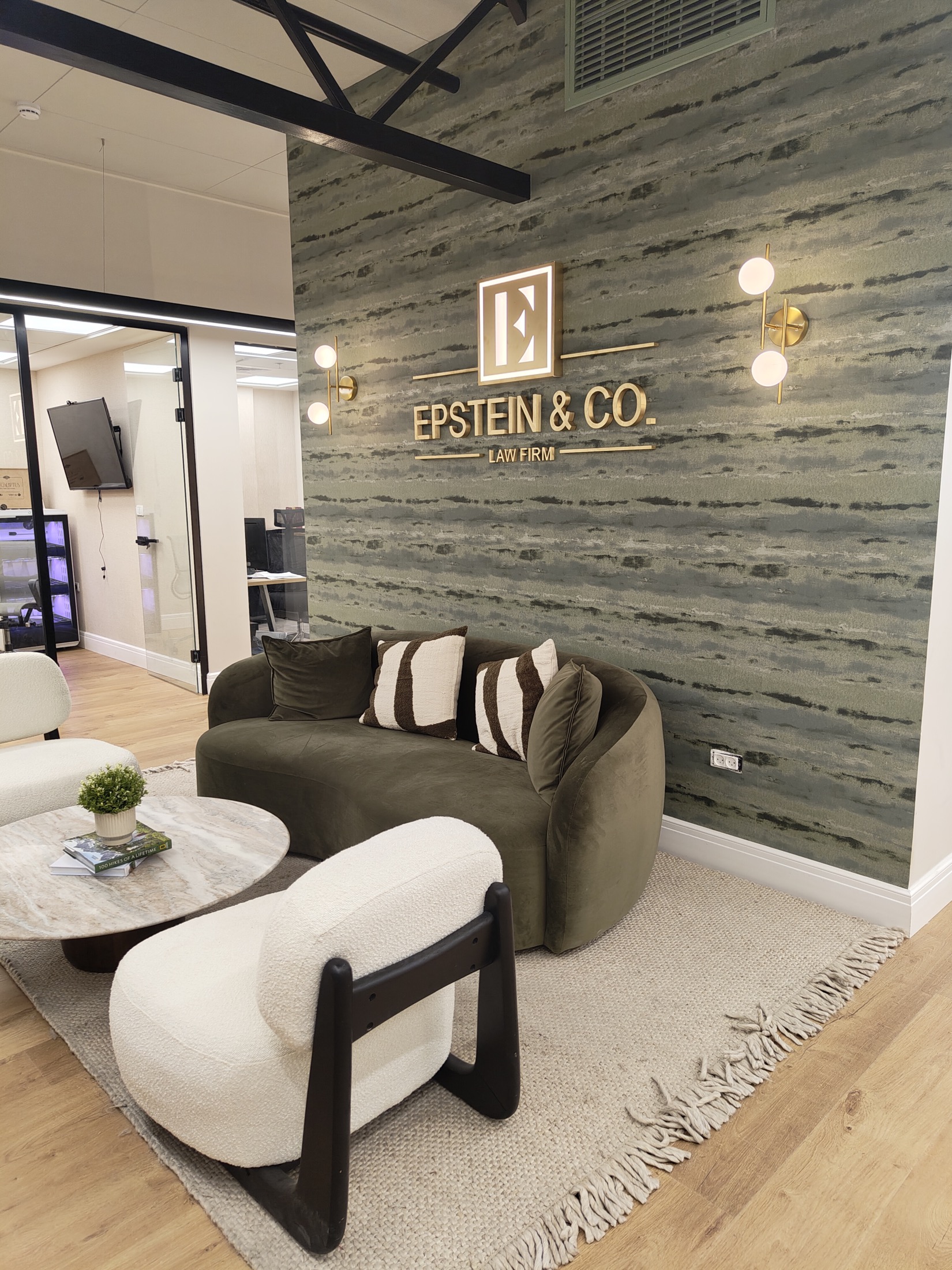 Office reception lounge with a velvet sofa and boucle armchairs